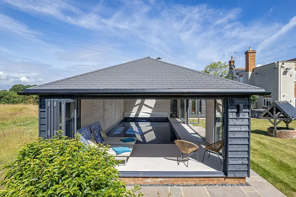 What does an indoor pool really cost in 2026? Indoor pool with bifold doors open